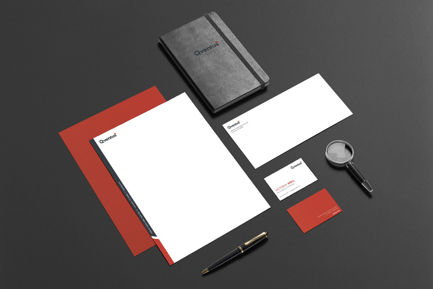Qventus stationery flatlay with notebook, letterhead, envelope, and business cards